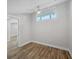 Light-filled bedroom with wood floors and a ceiling fan, offering a view into another room at 6030 Boca Grande Cswy # B21, Boca Grande, FL 33921