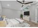 Inviting bedroom features a ceiling fan, wood-look floors, and a modern, vaulted ceiling at 6030 Boca Grande Cswy # B21, Boca Grande, FL 33921