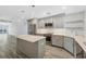 Open kitchen with stainless steel appliances, quartz counters, and modern gray cabinetry at 6030 Boca Grande Cswy # B21, Boca Grande, FL 33921