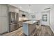 Bright kitchen featuring an island, stainless steel appliances, and stylish modern cabinetry at 6030 Boca Grande Cswy # B21, Boca Grande, FL 33921