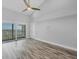 Airy main bedroom with balcony access, showcasing expansive views and light wood-look flooring at 6030 Boca Grande Cswy # B21, Boca Grande, FL 33921