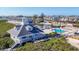 Aerial view of waterfront condos featuring a community pool, lake, and tropical landscaping at 6030 Boca Grande Cswy # B21, Boca Grande, FL 33921