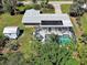 Property featuring a screened-in pool, storage shed, and a beautifully landscaped yard at 6181 Jack St, Venice, FL 34293