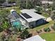 Beautiful aerial view with screened pool, solar panels, and a well-manicured lawn at 6181 Jack St, Venice, FL 34293