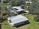 Expansive backyard with a large shed, screened-in pool, and lush greenery at 6181 Jack St, Venice, FL 34293