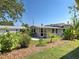 Private backyard featuring lush tropical landscaping, a patio, and a detached building at 6181 Jack St, Venice, FL 34293