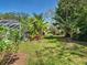A spacious lawn features mature landscaping and lush greenery at 6181 Jack St, Venice, FL 34293
