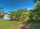 A lush backyard with banana trees and manicured lawn enhances the property's appeal at 6181 Jack St, Venice, FL 34293