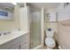 Cozy bathroom featuring a shower stall, toilet, vanity, and mirrored cabinet at 6181 Jack St, Venice, FL 34293