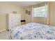 Cozy bedroom with a white dresser, window view, and a comfortable sleeping area at 6181 Jack St, Venice, FL 34293
