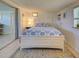 Cozy bedroom with white paneled walls, tile floor, and a sliding door leading to another room at 6181 Jack St, Venice, FL 34293