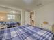 Bedroom with a mirrored closet and a view into an adjacent room at 6181 Jack St, Venice, FL 34293