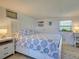 This cozy bedroom features a comfortable bed, bedside tables, and paneled walls at 6181 Jack St, Venice, FL 34293