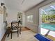 Dining room with a view of the pool and backyard, adjacent to a laundry area at 6181 Jack St, Venice, FL 34293