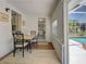 Dining room adjacent to pool area, showcasing natural light and backyard views at 6181 Jack St, Venice, FL 34293