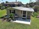 Quaint detached unit with patio area, charming decor, and a tranquil outdoor setting at 6181 Jack St, Venice, FL 34293