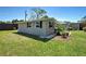 View of home exterior, highlighting the well-maintained lawn, and outdoor living space at 6181 Jack St, Venice, FL 34293