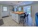 The kitchen showcases a butcher block island and an open layout leading to the outdoor pool area at 6181 Jack St, Venice, FL 34293
