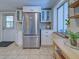 Bright kitchen with stainless steel refrigerator and white cabinets provides plenty of storage at 6181 Jack St, Venice, FL 34293