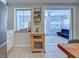 Open-concept kitchen with view into the lanai from windows provides natural light and views at 6181 Jack St, Venice, FL 34293