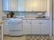 Efficient kitchen features classic white cabinets, essential appliances, and functional countertop space at 6181 Jack St, Venice, FL 34293