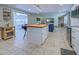 Open concept living room with kitchen island, living room and adjacent seating area at 6181 Jack St, Venice, FL 34293