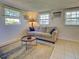 Living room featuring a comfortable sofa, coffee table, and bright windows at 6181 Jack St, Venice, FL 34293