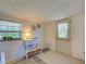 Bright living room showcasing a window, decorative accents, and a door leading outside at 6181 Jack St, Venice, FL 34293