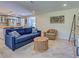 Open living room view of the kitchen featuring blue couch and stylish furnishings at 6181 Jack St, Venice, FL 34293