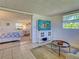 Open-concept area featuring a tv and entertainment area plus views into the bedroom at 6181 Jack St, Venice, FL 34293