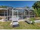 Outdoor patio with screened enclosure, dining set, and a view of the pool at 6181 Jack St, Venice, FL 34293