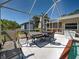 Covered pool deck area complete with outdoor seating for enjoying the Florida sunshine and relaxation at 6181 Jack St, Venice, FL 34293