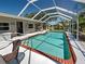 Screened pool with outdoor seating, well-maintained landscaping and a cozy seating area at 6181 Jack St, Venice, FL 34293