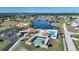 Aerial view showcasing community amenities: pool, lake, tennis courts, shuffleboard and recreation center at 6540 Coliseum Blvd, Port Charlotte, FL 33981