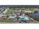 Aerial view featuring community amenities: pool, shuffleboard courts, tennis court, and recreation center at 6540 Coliseum Blvd, Port Charlotte, FL 33981