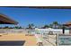 Community pool area with lounge chairs, umbrellas, and clear blue skies at 6540 Coliseum Blvd, Port Charlotte, FL 33981