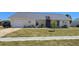 Charming single-story home with a well-maintained lawn and an attached two-car garage at 6540 Coliseum Blvd, Port Charlotte, FL 33981