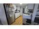 Efficient kitchen featuring white cabinets, tile flooring, and stainless steel appliances at 6540 Coliseum Blvd, Port Charlotte, FL 33981