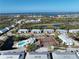 Expansive aerial view showcasing community amenities including a pool, tennis courts, and waterfront location at 6800 Placida Rd # 1004, Englewood, FL 34224