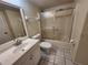 Bathroom with a sliding glass door shower, sink with vanity, toilet, and tiled flooring at 6800 Placida Rd # 1004, Englewood, FL 34224