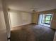 Generously sized bedroom with carpet flooring, a ceiling fan, and access to an outdoor patio at 6800 Placida Rd # 1004, Englewood, FL 34224