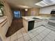 Bright kitchen features white cabinets, appliances, and a breakfast bar overlooking the adjacent living area at 6800 Placida Rd # 1004, Englewood, FL 34224