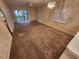 Inviting living room featuring neutral carpet, a ceiling fan, and sliding glass doors to the outdoor area at 6800 Placida Rd # 1004, Englewood, FL 34224