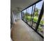 Screened lanai featuring a ceiling fan with landscaping and palm trees view at 6800 Placida Rd # 1004, Englewood, FL 34224