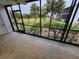Screened in lanai patio with view of landscaping and palm trees at 6800 Placida Rd # 1004, Englewood, FL 34224