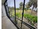 Enclosed patio with view of palm trees and landscaped yard at 6800 Placida Rd # 1004, Englewood, FL 34224