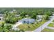 A large house with a backyard pool area, surrounded by trees and lush greenery at 7108 Harle Ave, North Port, FL 34291