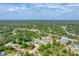 A serene aerial view of the property nestled among lush greenery and neighboring homes at 7108 Harle Ave, North Port, FL 34291