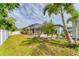 Beautiful backyard with a screened-in lanai, lush landscaping, and a privacy fence at 7108 Harle Ave, North Port, FL 34291