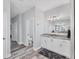 Bright bathroom featuring gray cabinets, gray countertops, and vanity lighting at 7108 Harle Ave, North Port, FL 34291